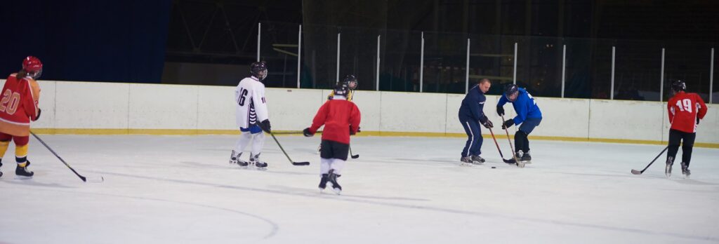 teen ice hockey players team meeting with trainer