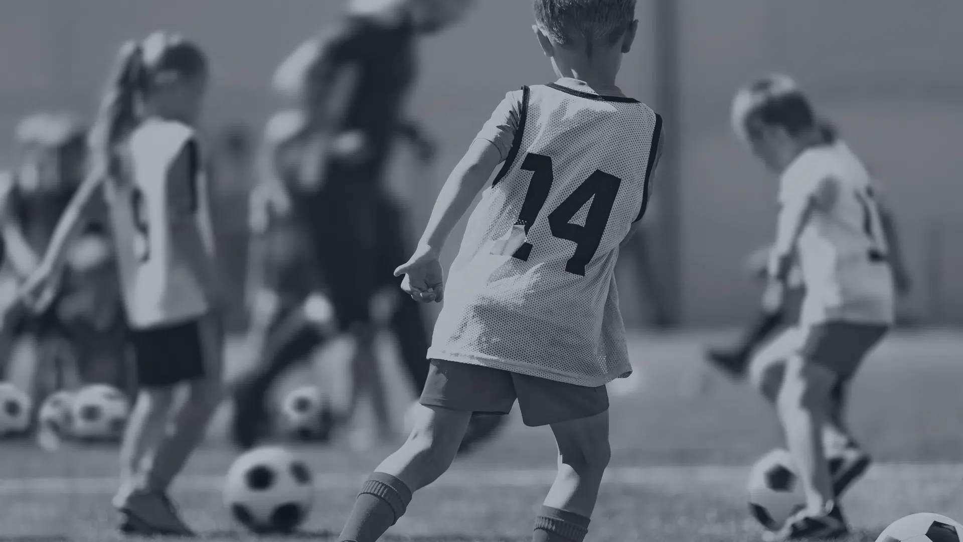 Young soccer players practicing on a community field, highlighting the importance of local youth sports funding.